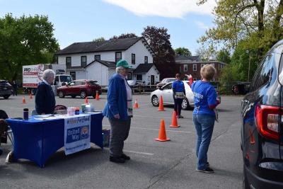 woman directs car to shredding truck